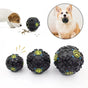 Black textured dog toys with paw prints on a white background, accompanied by a dog eating from a bowl. Tough Chews